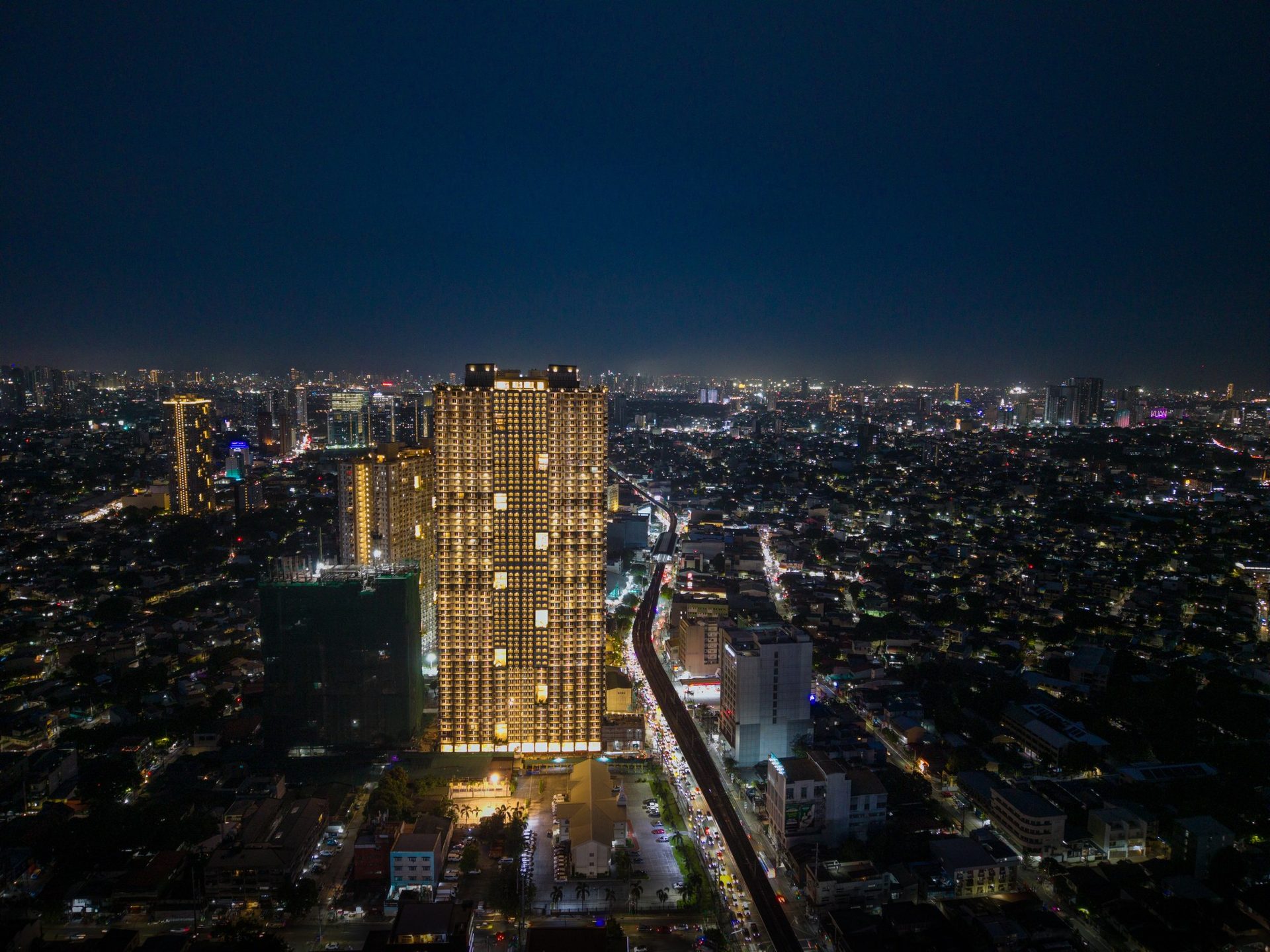 The Oriana North Tower at night — RFO DMCI Homes condominium on Aurora Boulevard, Quezon City